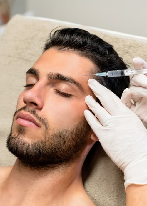Man Getting Head treatment with a needle - injection